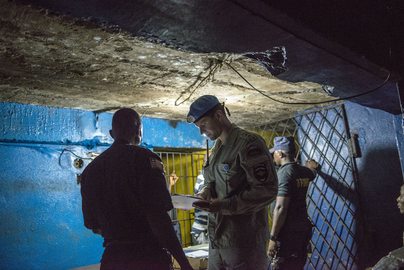 A Russian UNPOL Officer checks in with Liberian National Police at a Police Depot in Congo Town, Monrovia, Liberia, Sunday 2 February 2014, during a routine night patrol with Indian FPU officers, in Central Monrovia. UNMIL Photo/Staton Winter